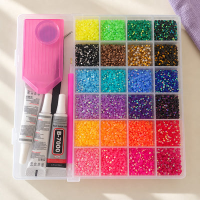 Bedazzling kit with 24 rhinestone colors, sorting tray, applicator pen and B-7000 glue