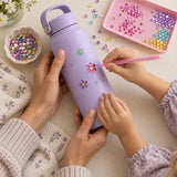 Decorating a water bottle with rhinestones