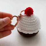 Crochet cupcake keychain with heart-shaped metal clasp held in hand