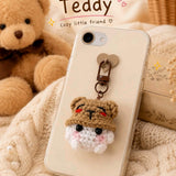 Teddy crochet phone charm with brown bear hat on a phone